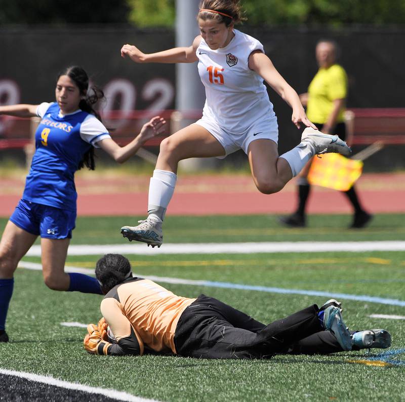 Crystal Lake Central’s Ava Knapp leaps over De La Salle goalkeeper Emily Samuels in the IHSA girls Class 2A third-place soccer game at North Central College in Naperville on Saturday, June 3, 2023.