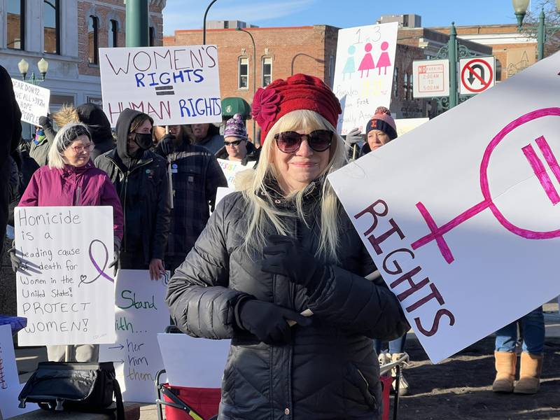 Safe Passage executive director Mary Ellen Schaid holds a sign after speaking to a crowd that gathered at 9 a.m. to advocate for women's rights on Saturday, Jan. 18, 2025, near the DeKalb County Courthouse in downtown Sycamore. The local rally was held on the same day as the national women's march organized in Washington, D.C. days before Donald Trump's second presidential inauguration.