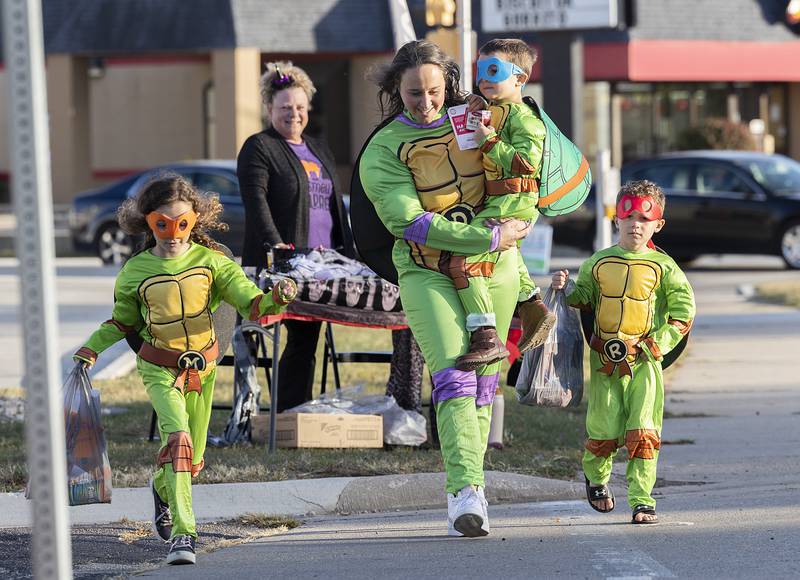 Dressed as the Teenage Mutant Ninja Turtles mom Rachel Hallstrom hits the Rock Falls downtown with her brood Kennedy (left), 7, McClain, 5, and Johan, 5, Friday, Oct. 25, 2024, for the Biz Boo Trick or Treat event.