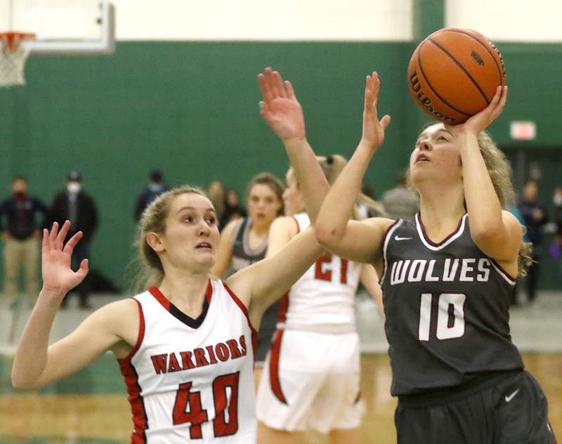 Prairie Ridge's Elani Nanos, right, drives to the basket  against Deerfield's Morgan Kerndt during a IHSA Class 3A Grayslake Central Sectional semifinal basketball game Tuesday evening, Feb. 22, 2022, between Prairie Ridge and Deerfield at Grayslake Central High School.