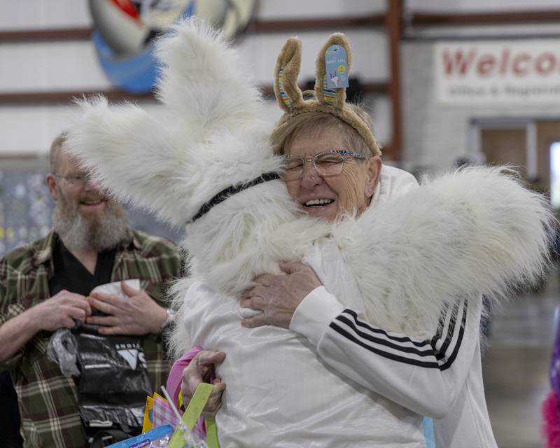 Christa Cross hugs the Easter Bunny during the Easter Egg hunt at Skydive Chicago on April 7, 2024.