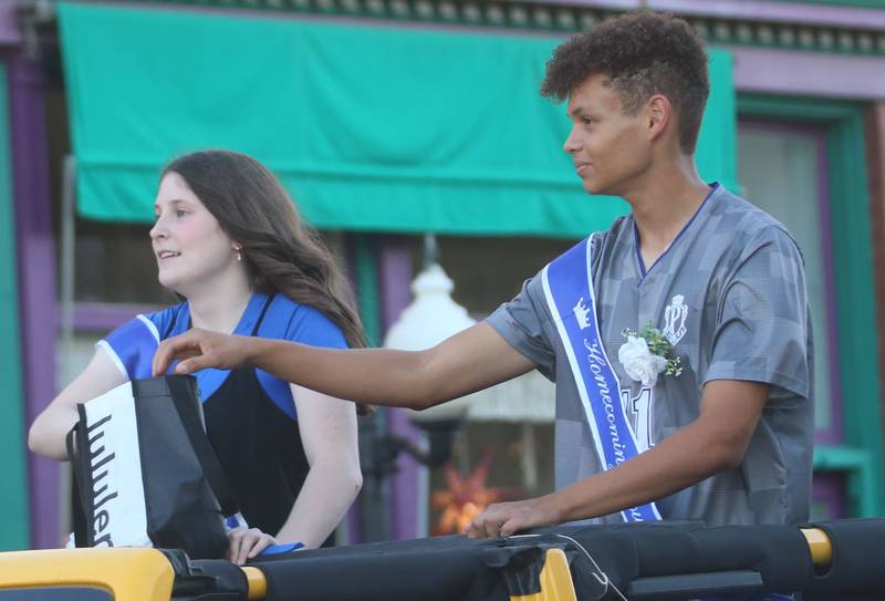 Senior court attendants Camryn Driscoll and Levi Boggs ride during the Princeton High School homecoming parade on Thursday, Sept. 25, 2025 along South Main Street in Princeton .