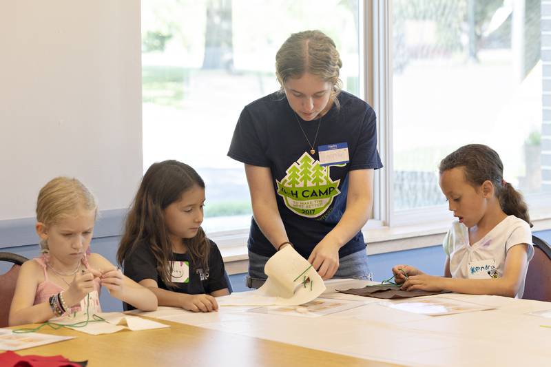 Ariya (left), Destiny, instructor Hannah Zinke and Kendra work on suturing skills Monday, July 28, 2025, during a workshop on veterinary medicine.
