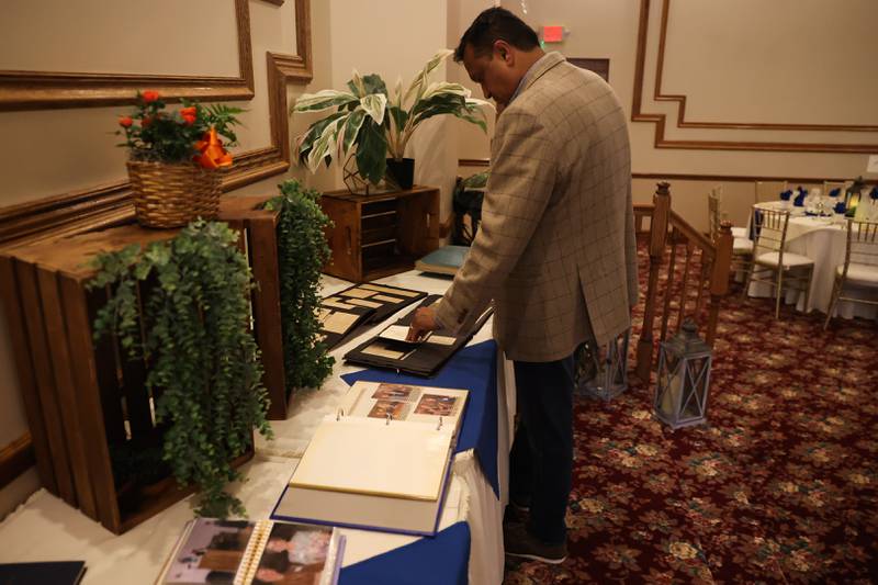 Srinin Namasivayam, President of the Naperville Sunrise Rotary Club, looks over a history display at a luncheon to celebrate the 110th anniversary of the Rotary Club at Jacob Henry Mansion on Tuesday, Aug. 1 in Joliet.