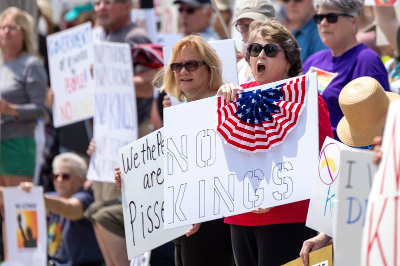 Protester holds sign and chants “no kings” on Saturday, June 14, 2025 at Rotary Park in Princeton.