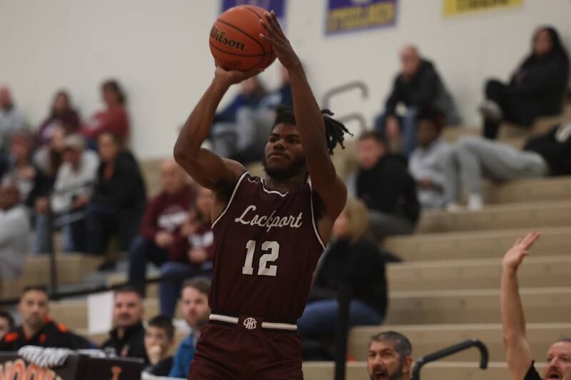 Lockport’s Jalen Falcon puts up the outside shot against Minooka.