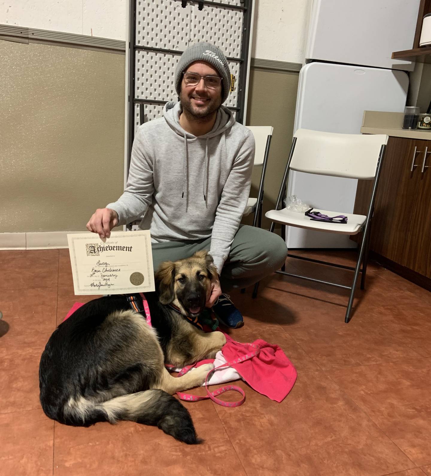 Ryan Evans of Minooka poses with Lucy, 1, a shepherd mix. All four of the Evans' family pets died as a result of a fire at the home on Labor Day.