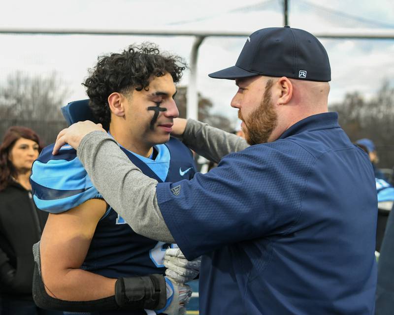 Nazareth Academy running back and linebacker coach Mike Stella talks with Nazareth Academy's Noah Sanchez (9) after falling short to Fenwick during the 6A semifinals overtime game on Saturday Nov. 22, 2025, held at Nazareth Academy High School in La Grange Park.