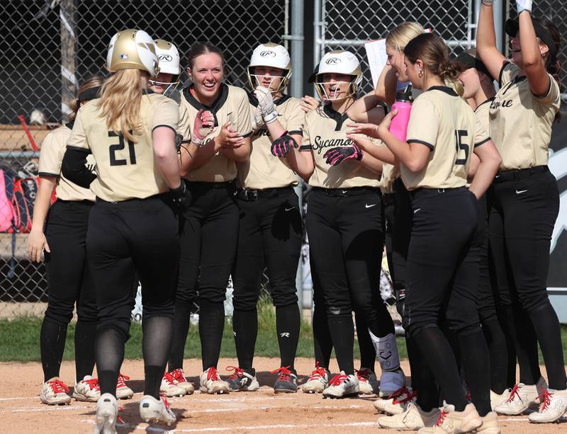 Sycamore's Ellison Hallahan heads to her team at home plate after homering during their game Wednesday, May 7, 2025, at Kaneland High School in Maple Park.