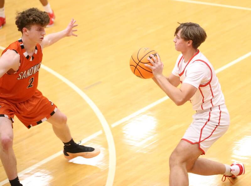 Ottawa's Connor Diederich looks to pass the ball around Sandwich's Griffin Somlock on Wednesday, Dec. 4, 2024 in Kingman Gym at Ottawa High School.