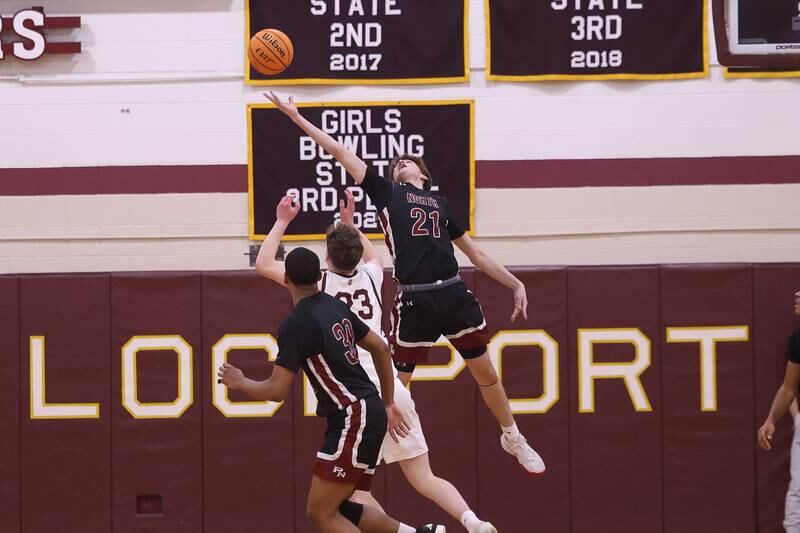 Plainfield North’s Joseph Charbonneau stretches for a rebound against Lockport on Friday, Jan. 3, 2025 in Lockport