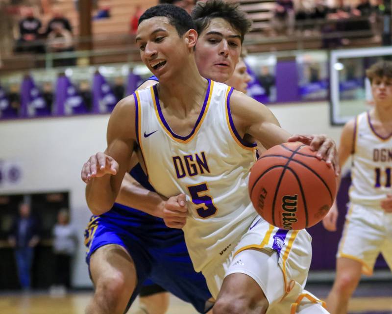 Downers Grove North's Jacob Bozeman (5) drives to the basket during varsity basketball game between Lyons at Downers Grove North.  Jan 31, 2023.