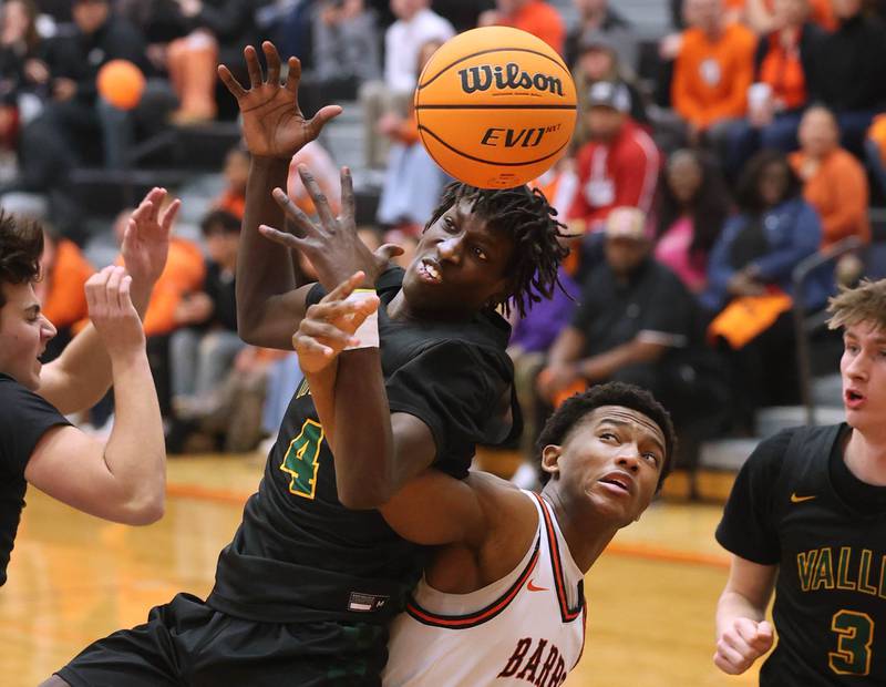 Waubonsie Valley's Moses Wilson and DeKalb's Justin O'Neal go after a rebound during their game Friday, Feb. 21, 2025, at DeKalb High School.