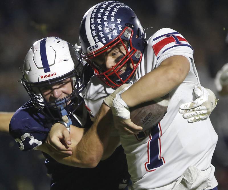 Cary-Grove's Lance Moore tackles Belvidere North's Andrew Bucci during an IHSA Class 5A quarterfinal playoff football game on Friday, November 14, 2025, at Cary-Grove High School, in Cary.