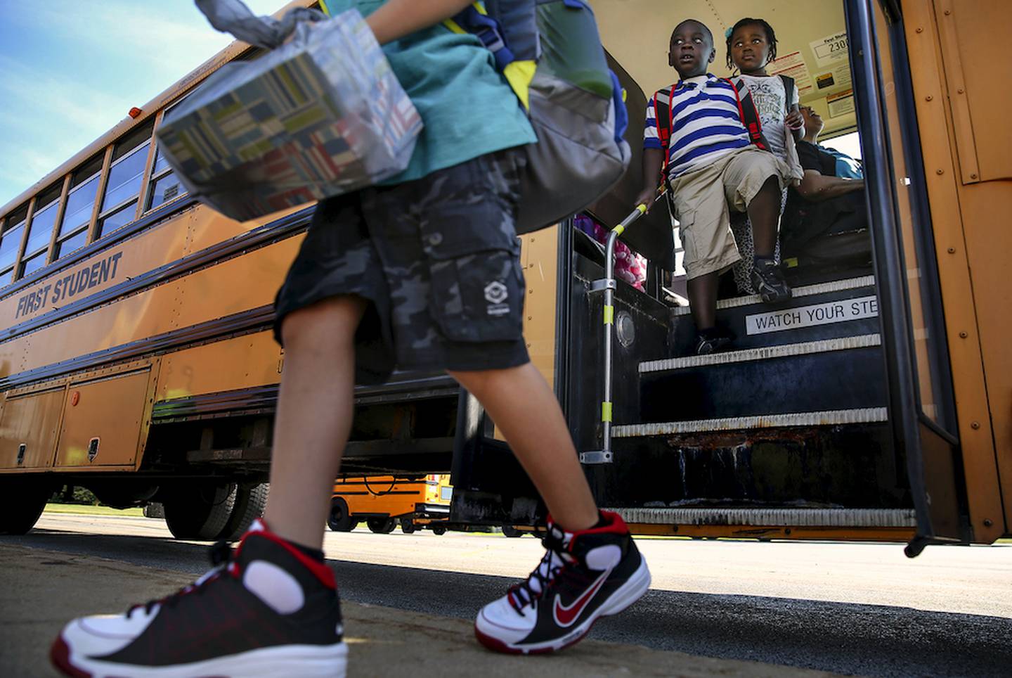Elementary school students step off their bus Thursday, Aug. 13, before the first day of school at Creekside Elementary School in Plainfield. Nearly 600 elementary students are registered with Creekside Elementary this year. Photo by Eric Ginnard - eginnard@shawmedia.com