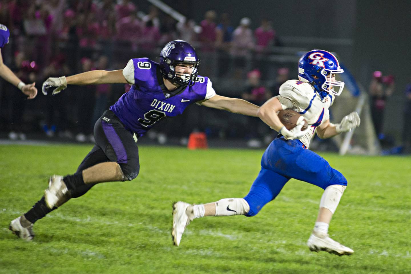 Genoa-Kingston's Ethan stays out of the reach of Dixon's Peyton Hale Friday, Oct. 8, 2021.