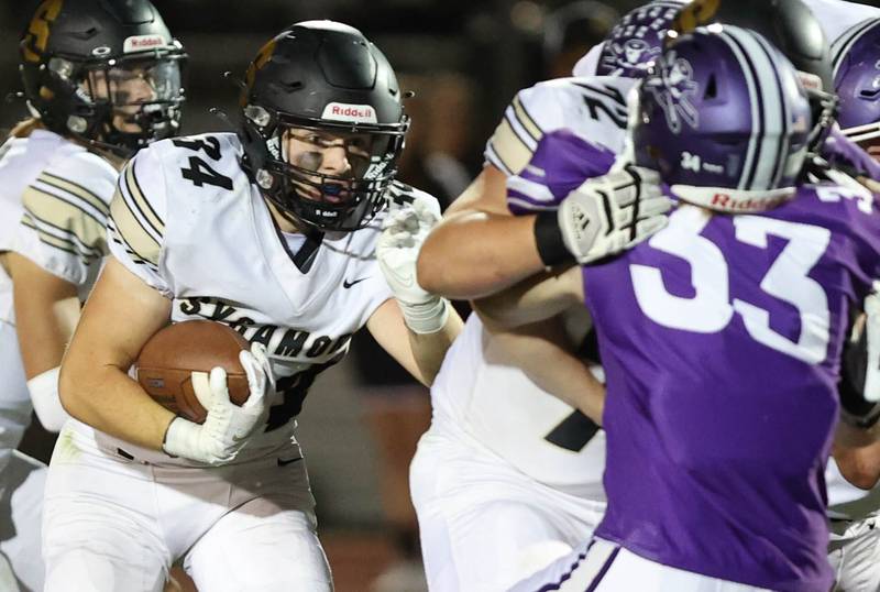 Sycamore's Joey Puleo follows a block from Lincoln Cooley to get through the Rochelle line during their game Friday, Sept. 23, 2022, at Rochelle High School.