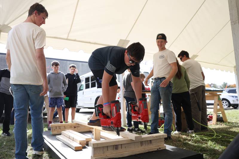A student works the nail guns at one of the trade skills tents at the Grundy Area Vocational Center 8th grade Career Fair at Morris High School on Tuesday, Oct. 29, 2024 in Morris