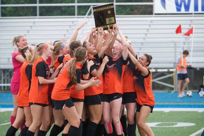 St. Charles East celebrates winning the Class 3A Regional Final over Wheaton North in Wheaton on May 20,2022.