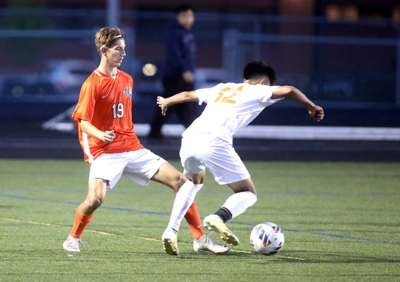 St. Charles East’s Ryan Groselak (left) tries to get the ball away from Crystal Lake Central’s Isaac Hernandez during a game at Streamwood on Tuesday, Sept. 12, 2023.