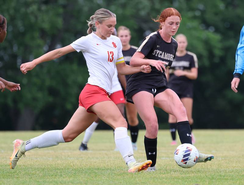 Sycamore's Isabelle Segreti kicks the ball away from Rock Island's Izzy Spurgetis Friday, May 22, 2026, during their Class 2A regional championship matchup at Sycamore High School.