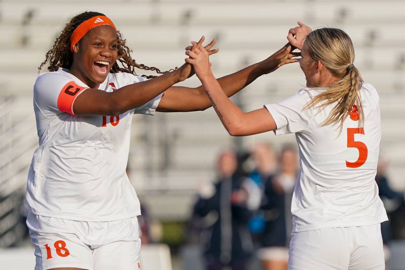 Oswego’s Jordyn Washington (18) celebrates with Aubrey Eirich (5) after Elrich scored a goal against Bartlett during a soccer mach in the Plainfield Classic  at Plainfield North High School on Tuesday, April 15, 2025.