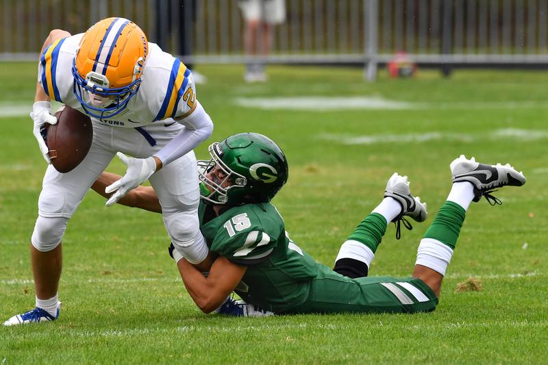 Glenbard West's Mason Ellens (15) tackles Lyons Township's Travis Stamm after a reception during a game on Sep. 16, 2023 at Glenbard West High School in Glen Ellyn.