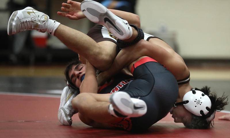 Jacobs’ Enrique Garcia tries to pin Huntley’s Julian Gutierrez during the 132—pound match of a Fox Valley Conference wrestling meet on Thursday, Dec. 11, 2025, at Huntley High School.