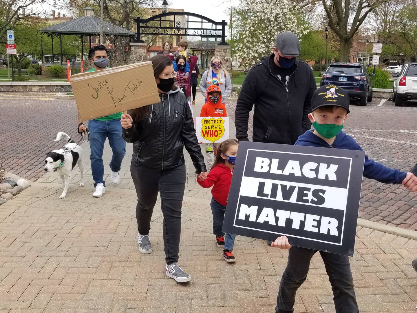 Merrill Hall, 8, was among about 40 people who marched around downtown Woodstock's Historic Square on Sunday, April 18, 2021, to protest police violence against immigrants and people of color.