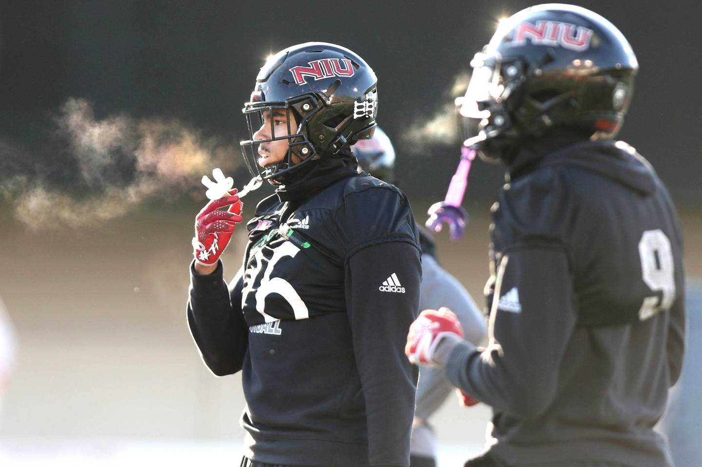 Northern Illinois University junior linebackers Jaden Dolphin (left) and Daveren Rayner get ready for a play on a chilly morning at spring practice Friday, April 7, 2023, in Huskie Stadium at NIU in DeKalb.