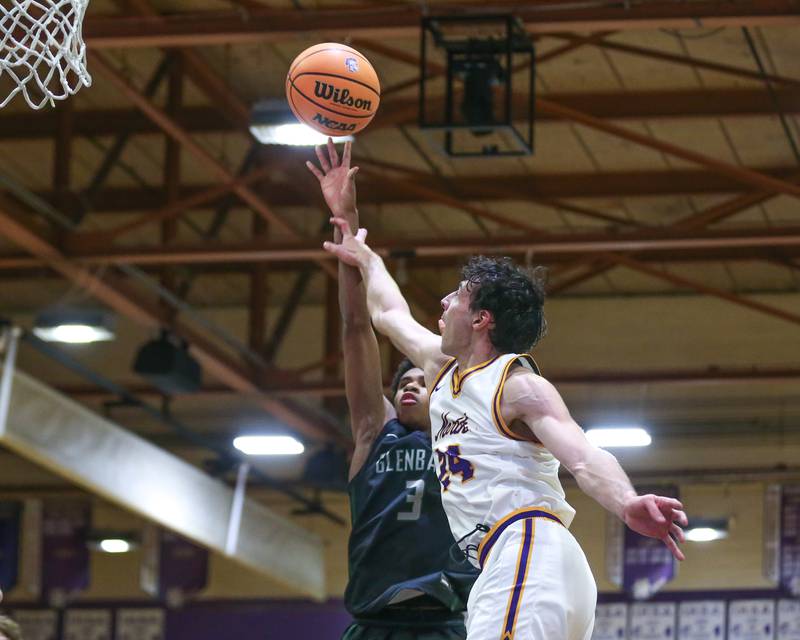 Glenbard West's TJ Williams (3) puts in one hander during their basketball game between Glenbard West at Downers Grove North. Jan 24, 2025 in Downers Grove.