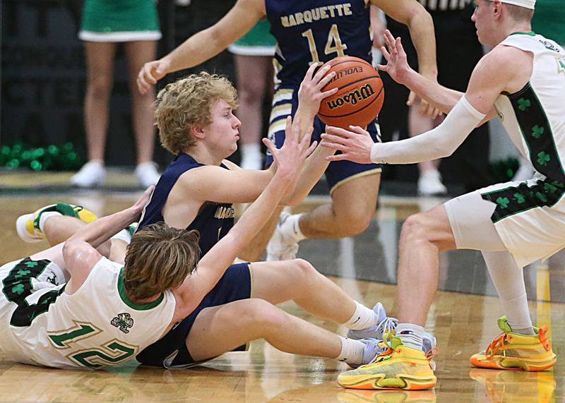Marquette's Griffin Walker dives on a loose ball as Seneca's Braden Ellis and teammate Paxton Giertz tries to get it back during the Tri-County Conference championship game on Friday, Jan. 27, 2023 at Putnam County High School.