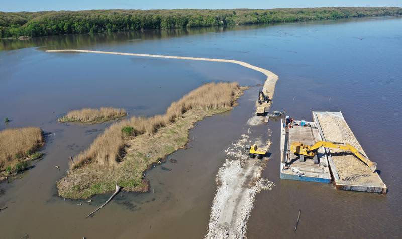 An aerial view of Delbridge Island just east of the Starved Rock Lock and Dam on Tuesday, April 30, 2024 near Starved Rock State Park. The Starved Rock Breakwater project is nearing compleation. The project is a habitat restoration effort designed to restore submerged aquatic vegetation in the Illinois River, Starved Rock Pool. It will increase the amount and quality of resting and feeding habitat for migratory waterfowl and improve spawning and nursery habitat for native fish.The breakwater structure will be approximately 6,100 feet long and constructed to a design elevation 461.85 feet, providing adequate protection to allow for submerged aquatic vegetation growth. The estimated total cost of this project is between $5 and $10 million.