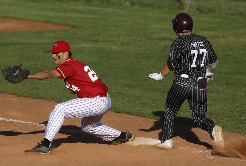 Deerfield's Tyler Bernstein fields the throw as Prairie Ridge's Gabriel Porter tries to leg out a hit during a Class 3A Deerfield baseball regional game on Wednesday, May 22, 2024, at the Deerfield High School.