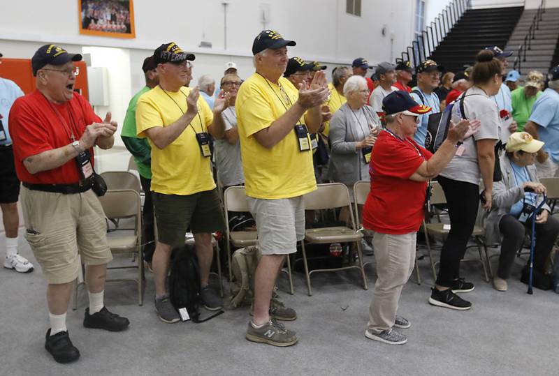 McHenry County Honor Flight veterans cheer for World War II U.S. Marine Corps veteran John Rickerd as he enters the McHenry Community High School’s gym for a homecoming celebration on Sunday, Aug. 27, 2023.