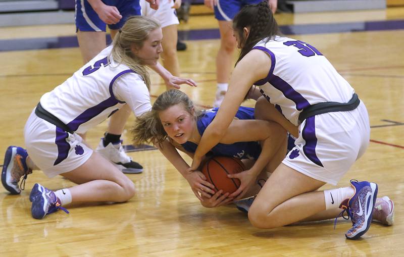 Burlington Central's Page Erickson battles for a loose ball with Hampshire's Avery Cartee (left) and Sophie Oleferchik during a Fox Valley Conference girls basketball game Friday, Jan. 20, 2023, at Hampshire High School.