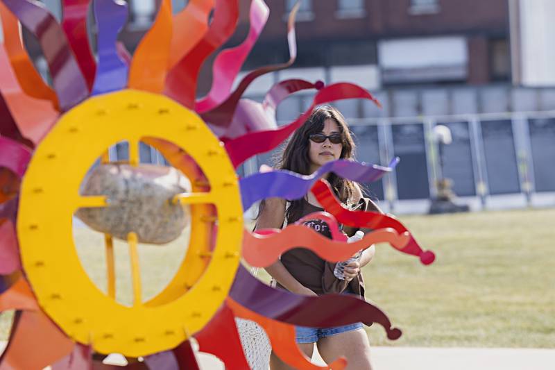 Chavela Quintana of Sterling passes by one of nine new sculptures in display Saturday, Sept. 2, 2023 at RB&W Park in Rock Falls. Rock Falls Tourism hosted a reception and opening for the new works.