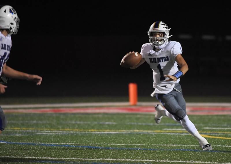 Warren’s Nate Foster looks to pass against Barrington at Barrington High School Friday, August 25, 2023.
