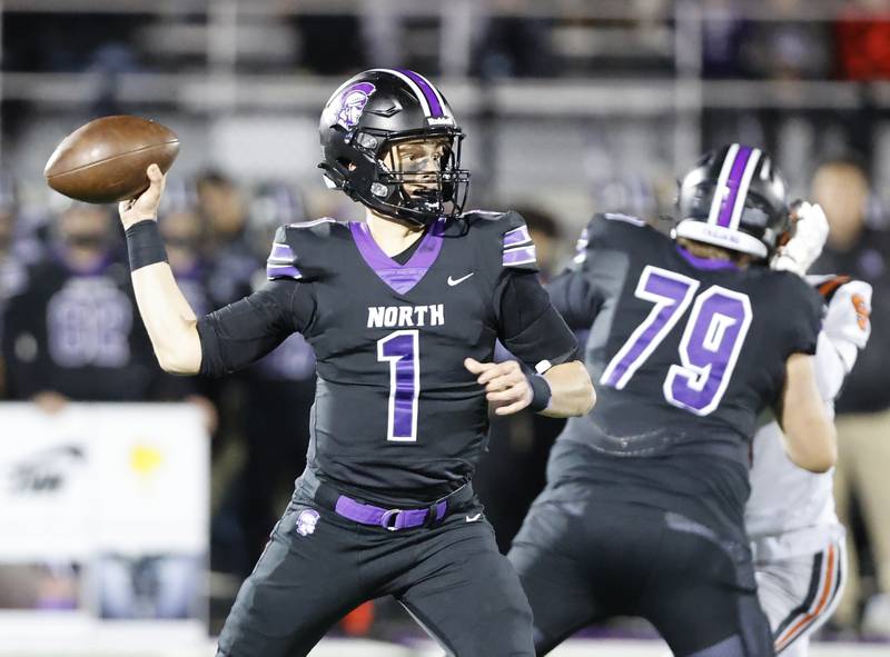Downers Grove North's Owen Lansu (1) starts to pass during the 7A first-round playoff game between Wheaton Warrenville South and Downers Grove North high schools on Friday, Nov. 1, 2024 in Downers Grove.