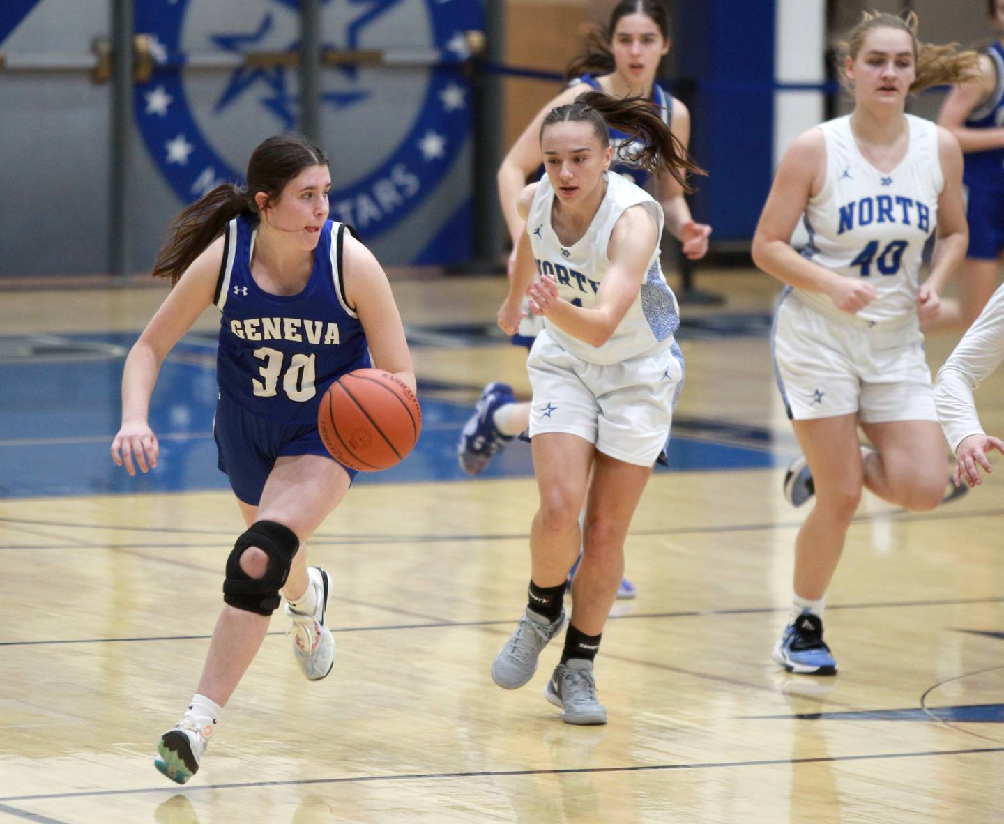 Geneva’s Keira McCann (left) dribbles the ball away from St. Charles North’s Laney Stark during a game at St. Charles North on Tuesday, Jan. 9, 2024.