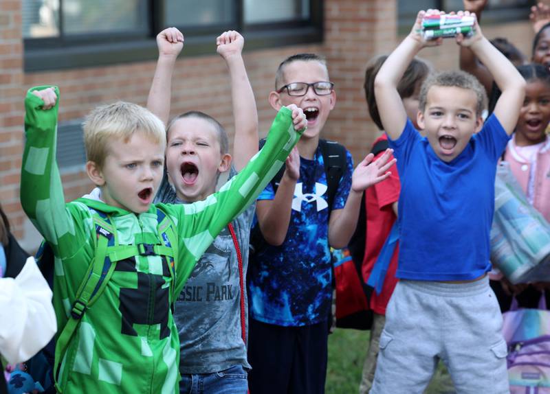 Lincoln Elementary School second graders give a cheer to show how excited they are to arrive for the first day of classes Wednesday, Aug. 14, 2024, at the school in DeKalb.