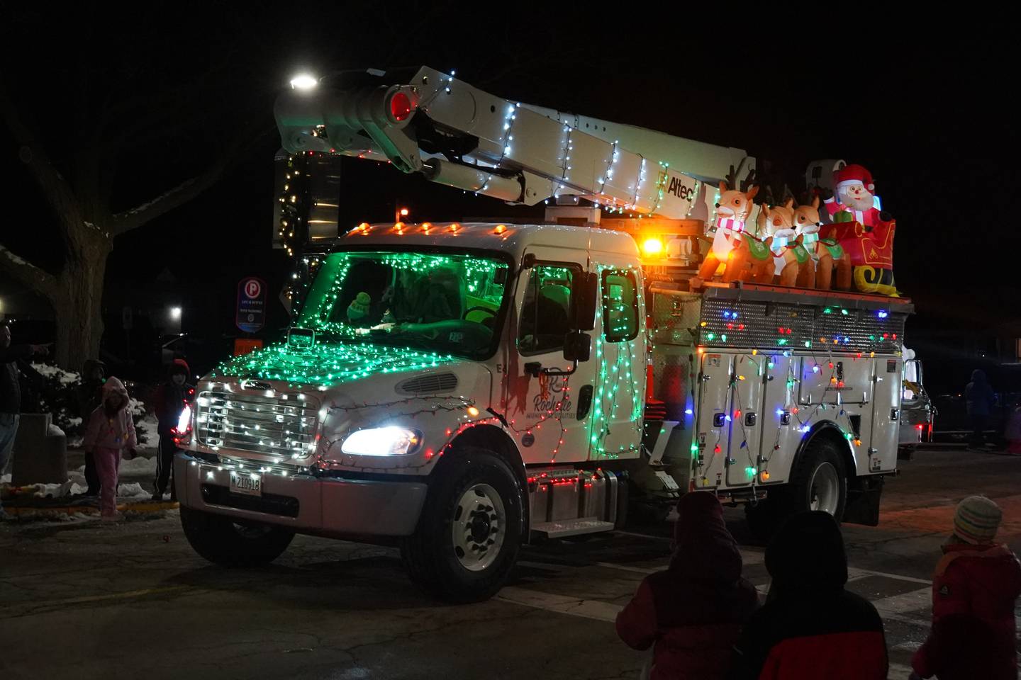 A Rochelle Municipal Utilities truck drives in Rochelle's lighted Christmas parade on Friday, Dec. 5, 2025.