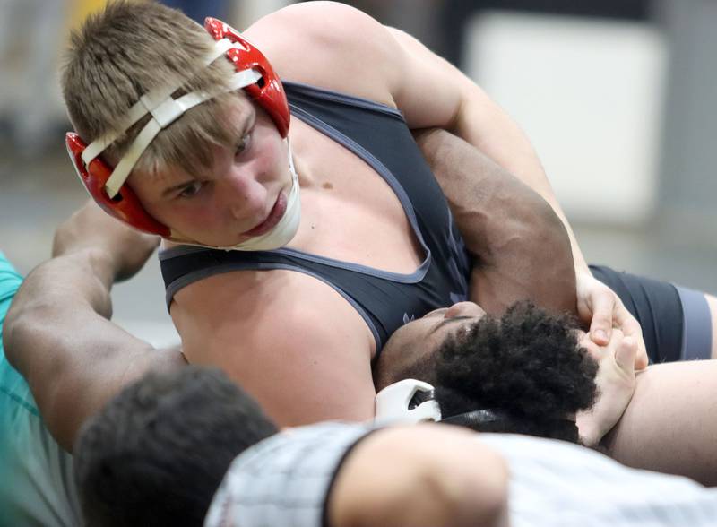 Marian’s Jimmy Mastny pins Woodstock North’s David Randecker at 215 pounds in boys wrestling IHSA Class 2A Regional championship bout action on Saturday, Jan. 31, 2026, at Harvard High School in Harvard.
