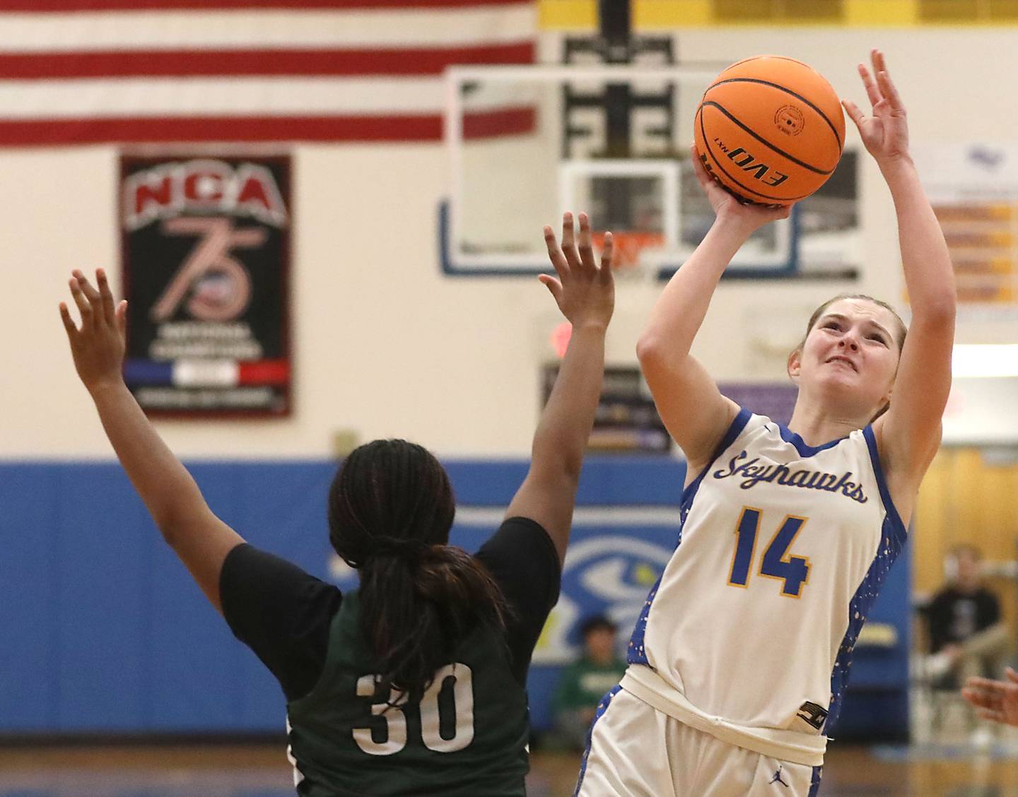 Johnsburg's Summer Toussaint (right) shoots the ball over St. Edward's Jordin Sauls during the IHSA Class 2A Johnsburg Sectional girls basketball championship game on Thursday, February, 26, 2026, at Johnsburg High School.