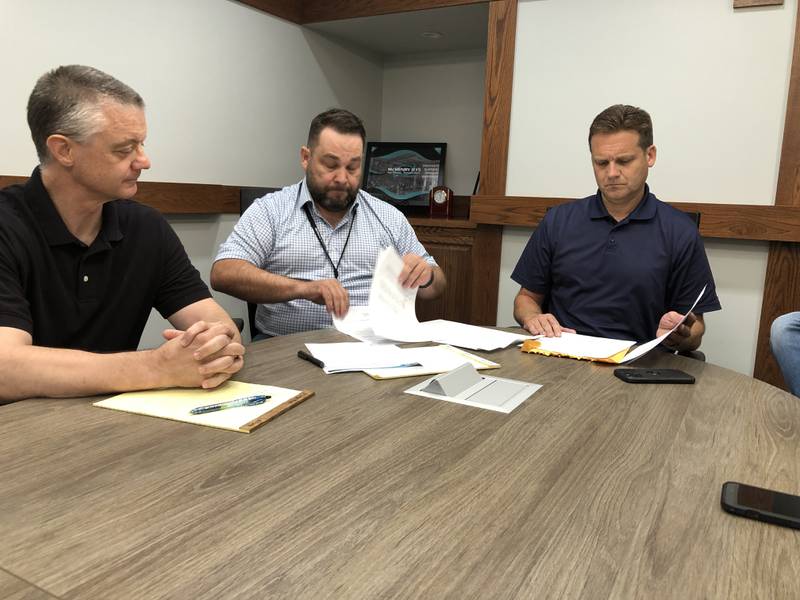 McHenry School District 15 Board President Chad Mihevc, left, Chief Financial Officer Jeff Schubert and Superintendent Josh Reitz opened two bids for Landmark School on Monday, July 28, 2025. The School Board is expected to vote on the bids at an August meeting.