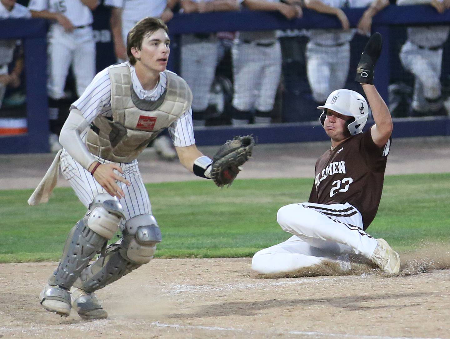 Joliet Catholic's Trey Swiderski scores a run as the throw comes in late to Quincy Notre Dame catcher Michael Stupavsky during the Class 2A state semifinals Friday, June 2, 2023, at Dozer Park in Peoria.