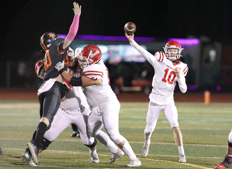 Naperville Central's Chris McCormack passes the ball past the outstretched arm of DeKalb's Nathan Sauer during their game Friday Oct. 7, 2022, at DeKalb High School.