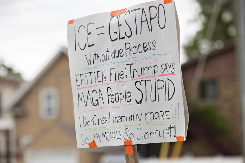 Signs showing protesters' dissatisfaction with the Trump administration are seen Thursday, July 17, 2025, during a gathering in Sterling.