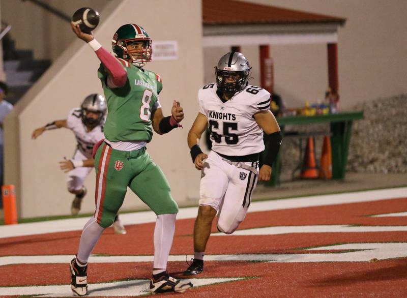 L-P quarterback Marion Persich throws the ball out of the endzone as Kaneland's Jackson Valentini approaches on Friday, Oct. 17, 2025 at Howard Fellows Stadium.