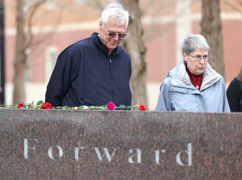 Linda Greer, mother of shooting victim Dan Parmenter, and her husband Robert Greer pay their respects during a remembrance ceremony Tuesday, Feb. 14, 2023, at the memorial outside Cole Hall at Northern Illinois University for the victims of the mass shooting in 2008. Tuesday marked the 15th year since the deadly shooting took place on campus which took the lives of five people.